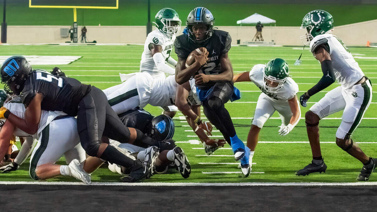 North Crowley quarterback Chris Jimerson Jr. scores on a 1-yard run against Arlington High on Friday September 1, 2013 at Crowley IDS Stadium in Fort Worth, Texas.