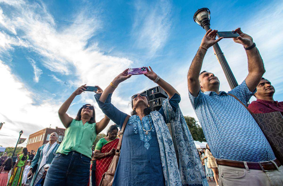 Proud parents in the audience getting video of their children performing at the celebration of Diwali in Southlake, Texas, Saturday, Oct. 22, 2022.