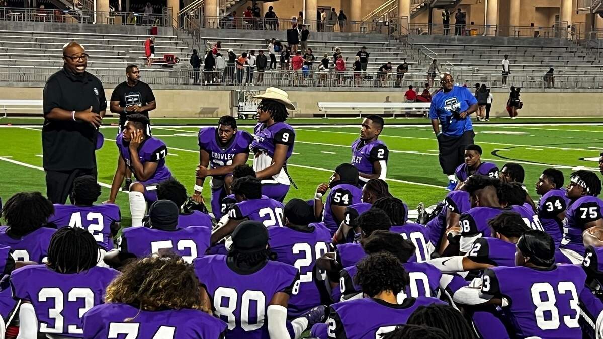 Crowley head coach Carlos Lynn addresses the Eagles after a 29-23 win over Mansfield Legacy on Thursday.