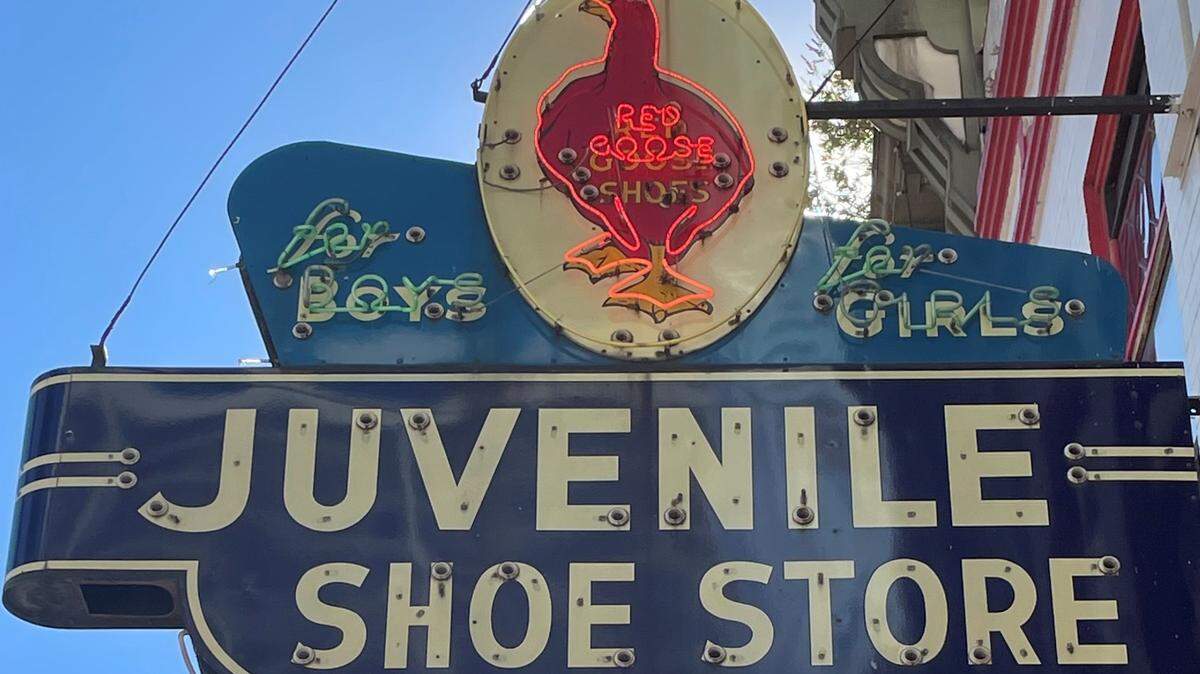 The iconic Red Goose Shoe sign, a downtown fixture since 1948, juts over the sidewalk at 306 N. Houston St.
