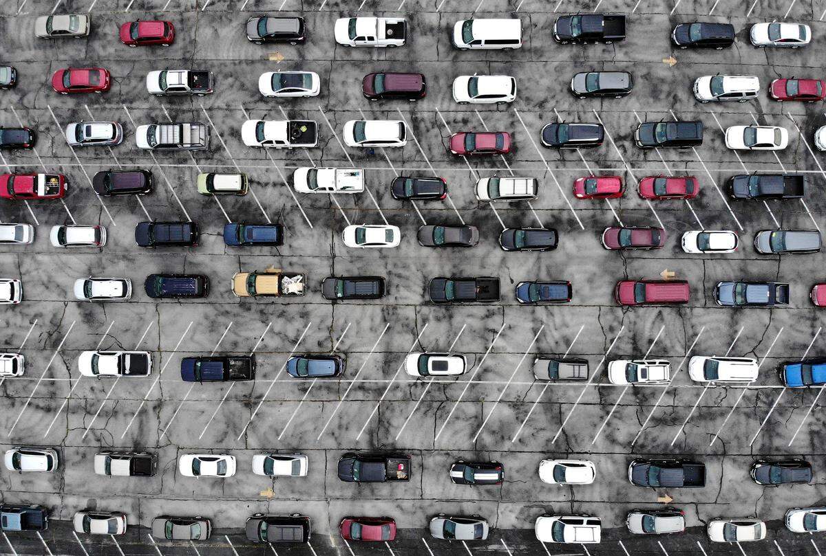 Cars line up for distribution of food through a Tarrant Area Food Bank event on Friday at the Tarrant County College Northwest campus. Hundreds of cars filled the distribution area and an overflow lot prior to the start of the event.