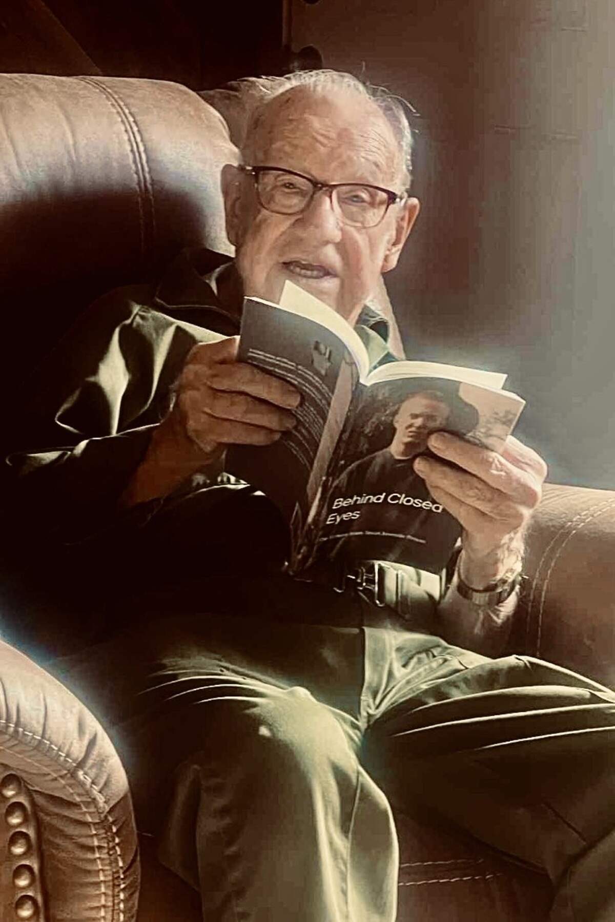 Retired juvenile probation officer Jack Gregg reading Leach’s book. Leach said Gregg was a kind man, one of the few bright lights during his time in the juvenile justice system.