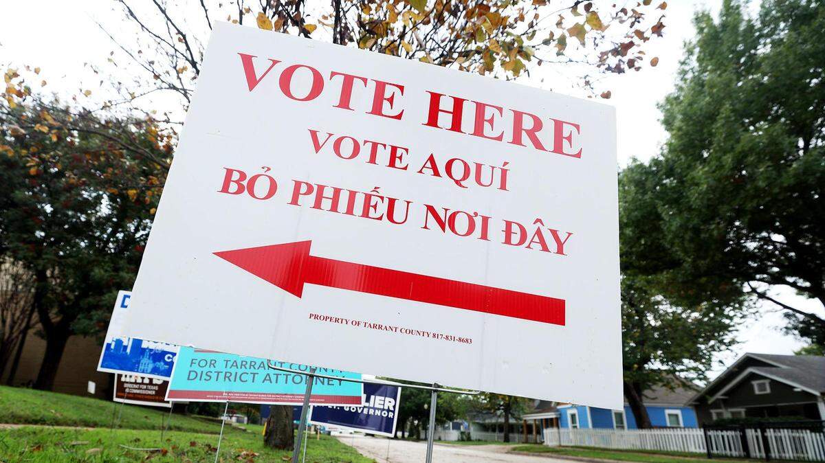 A voting sign outside of the polling site at Fire Station Community Center in Fort Worth. The sign reads: Vote Here. 