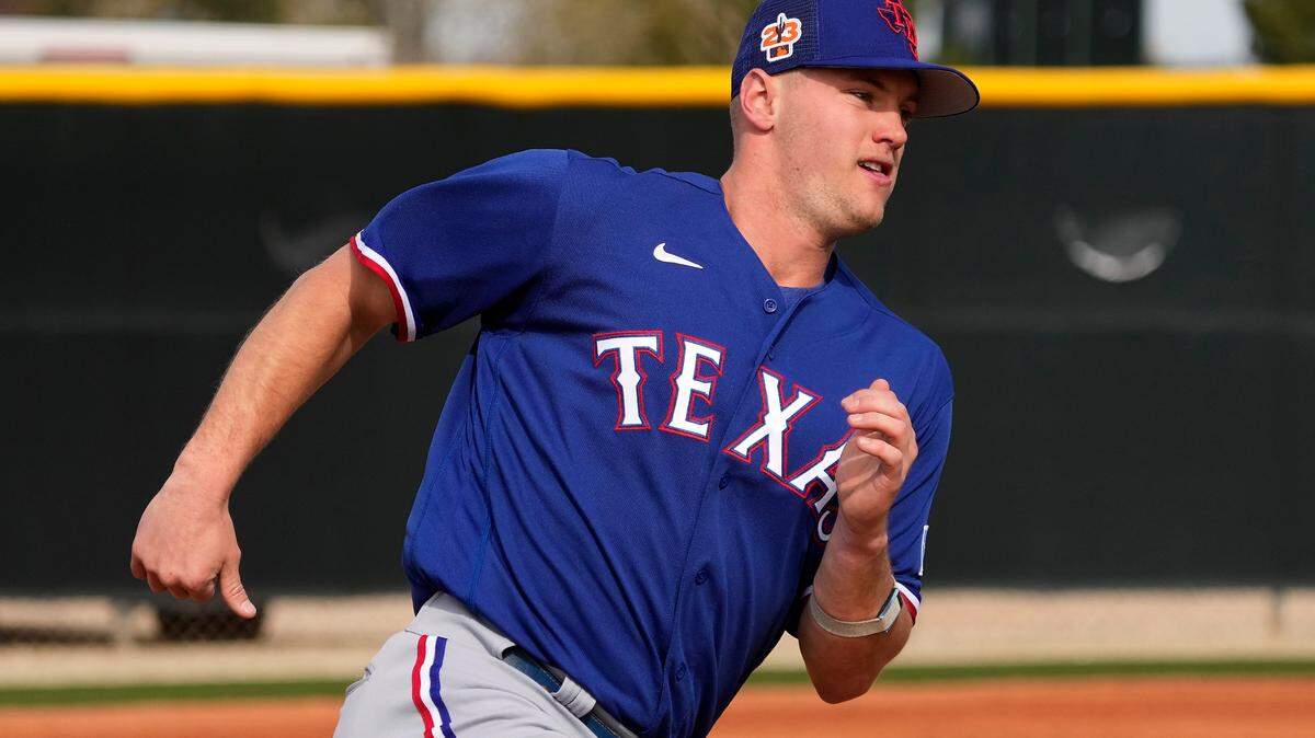 Texas Rangers third baseman Josh Jung runs the bases during spring training baseball practice Friday, Feb. 17, 2023, in Surprise, Ariz. (AP Photo/Charlie Riedel)