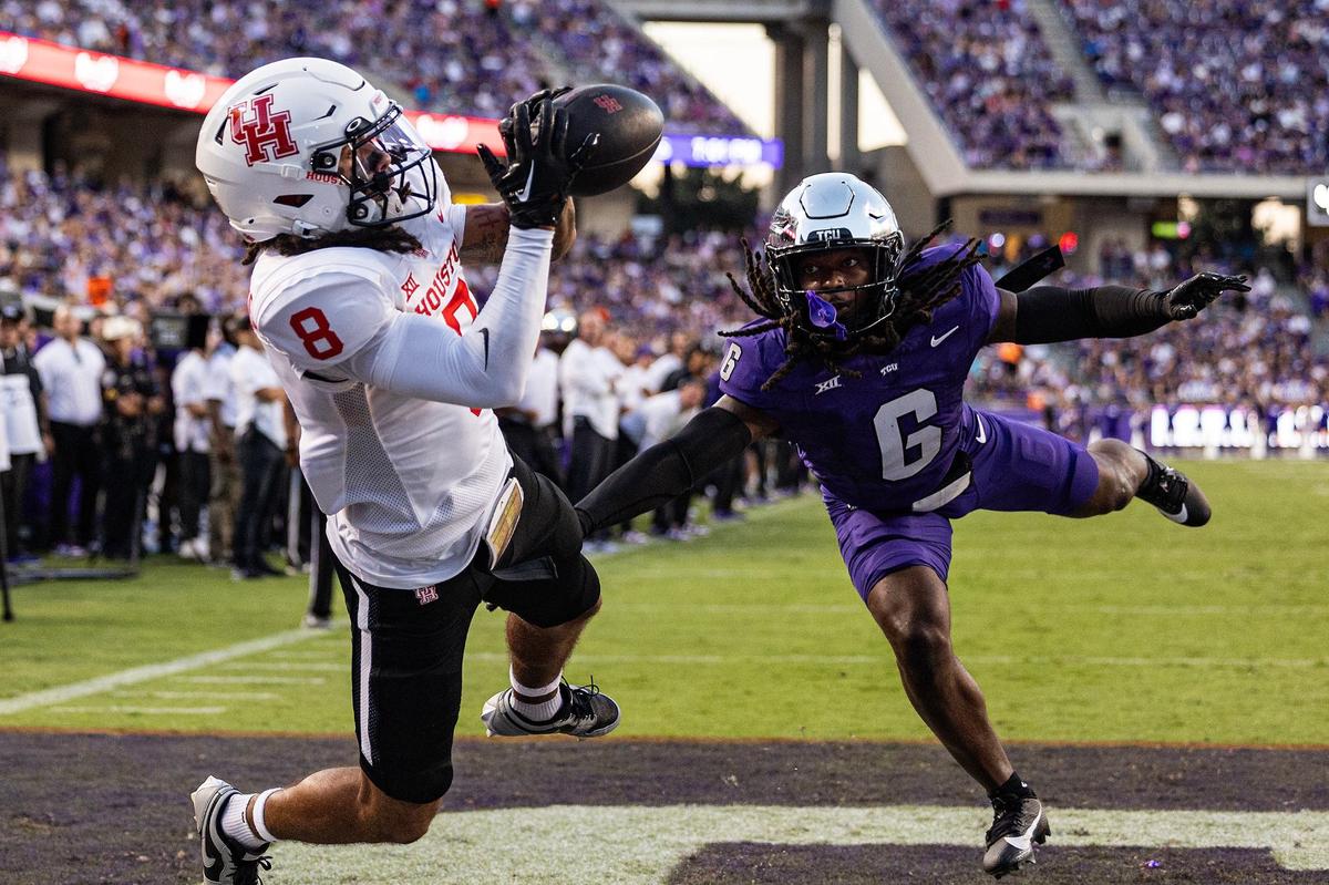 Houston wide receiver Devan Williams (8) catches a touchdown pass against TCU cornerback LaMareon James (6) in the first half of an NCAA football game at Amon G. Carter Stadium in Fort Worth on Friday, Oct. 4, 2024.