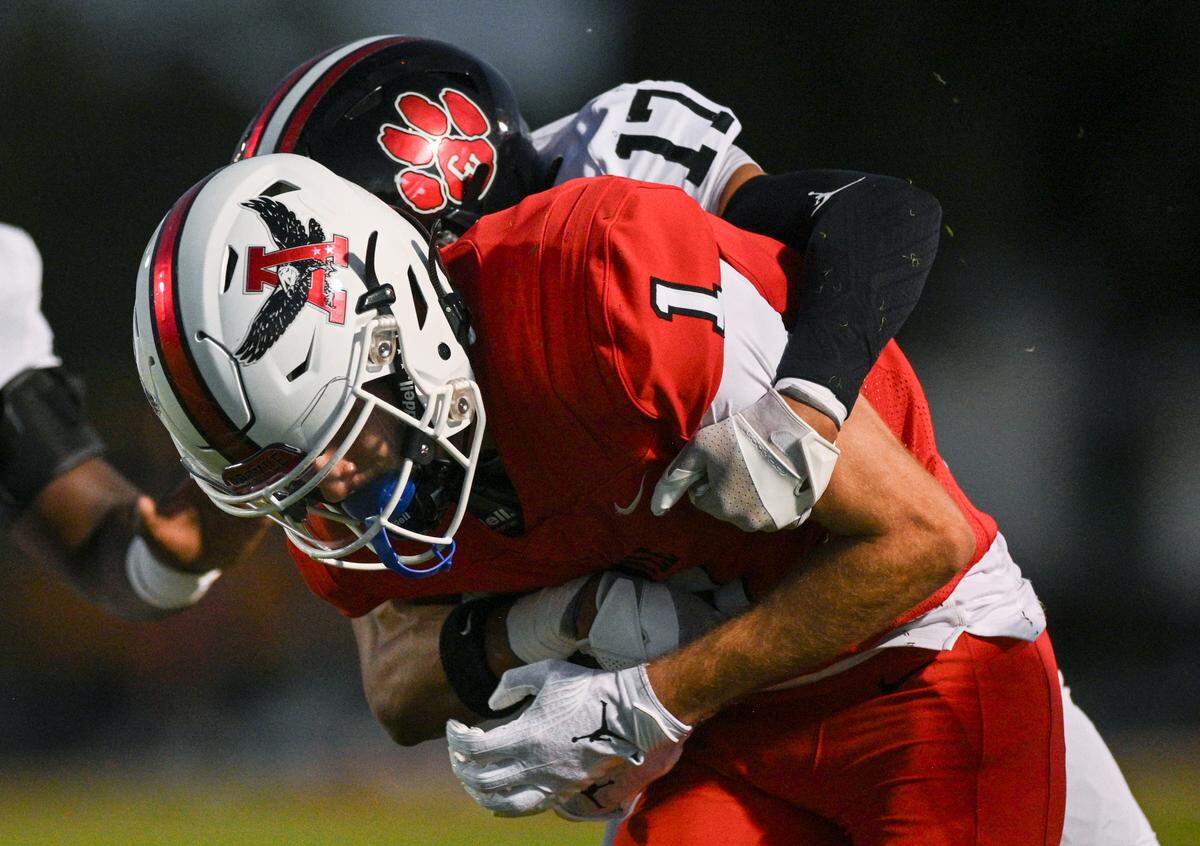 Argyle wide receiver Will Krzysiak (1) gets tackled by Colleyville Heritage defensive back De’drien Gaines (17) during a UIL football game at Eagle Stadium in Argyle, Texas on Friday, Sept. 27, 2024.