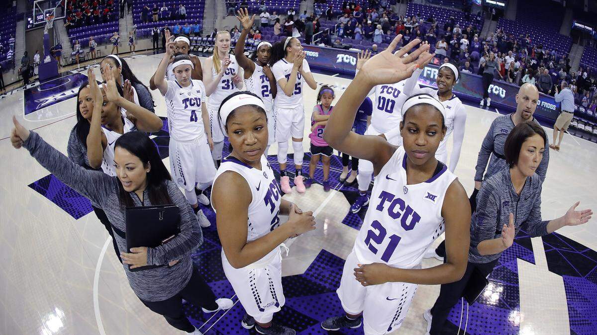 The TCU Frogs, including guard Lauren Heard (20) and forward Sydney Coleman (21) in the front, share thanks with fans after Thursday's 80-68 win over Lamar in the first round of the women's NIT.