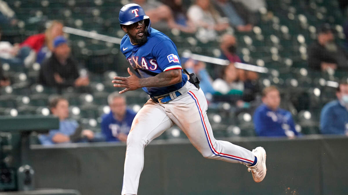 Texas Rangers’ Adolis Garcia heads home to score against the Seattle Mariners during the ninth inning of a 3-2 loss Saturday night. Garcia had three of the Rangers’ four hits.