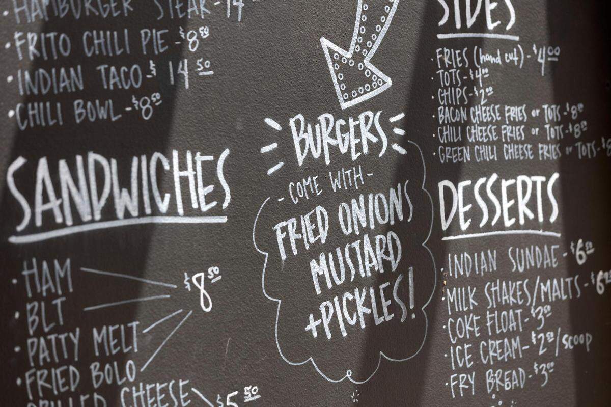 A standard burger from Hookers Grill comes with mustard, pickles and fried onions cooked with the patty of Hereford beef, photographed at the restaurant in downtown Fort Worth on Friday, June 17, 2022.