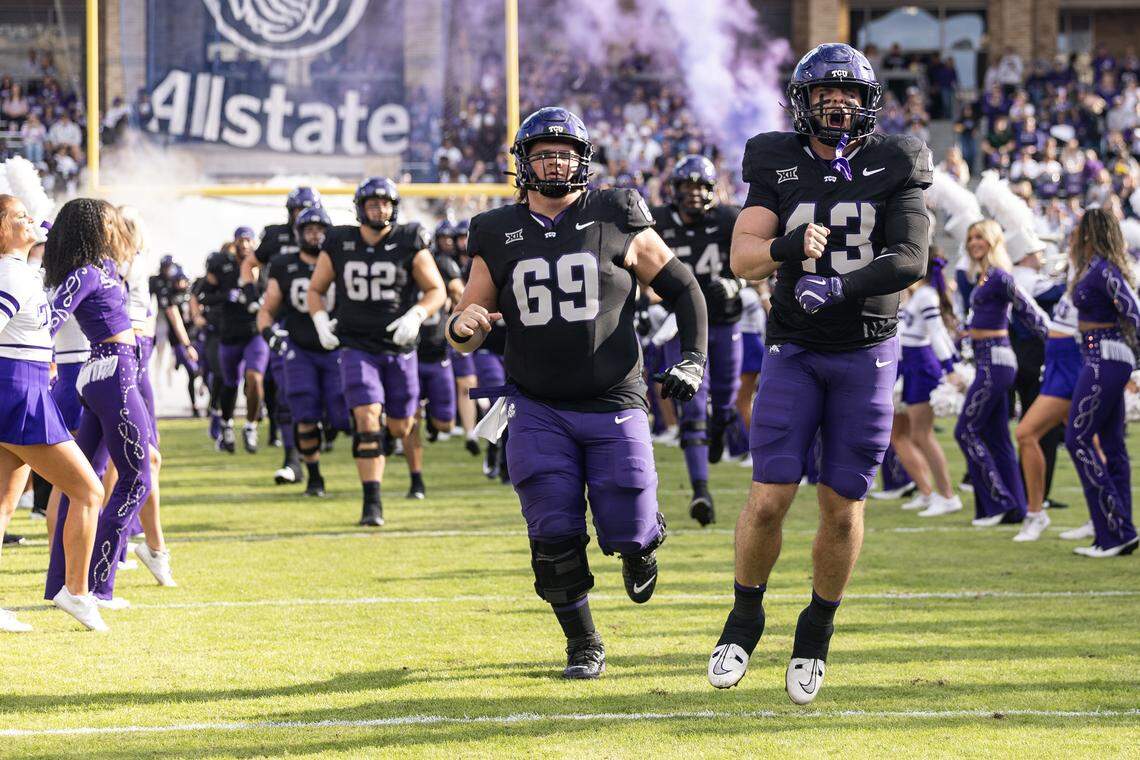 The TCU football team emerges from the tunnel prior to the first half of a Big XII conference game between the TCU Horned Frogs and the Cincinnati Bearcats at Amon G Carter Stadium in Fort Worth on Saturday, Nov. 29, 2025.