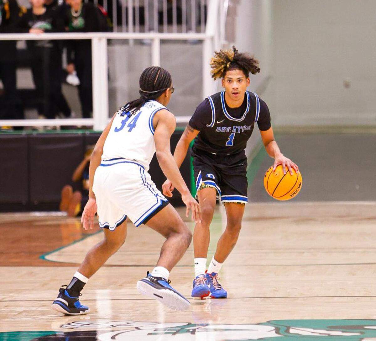 Javen Colbert (1) of Decatur brings the ball up the court against Rylan Brown (34) of Fort Worth Eastern Hills in a Class 4A Division 1 bi-district game on Monday, February 17, 2025 at Azle High School. Colbert scored 30 points to help Decatur win 65-63 in overtime.