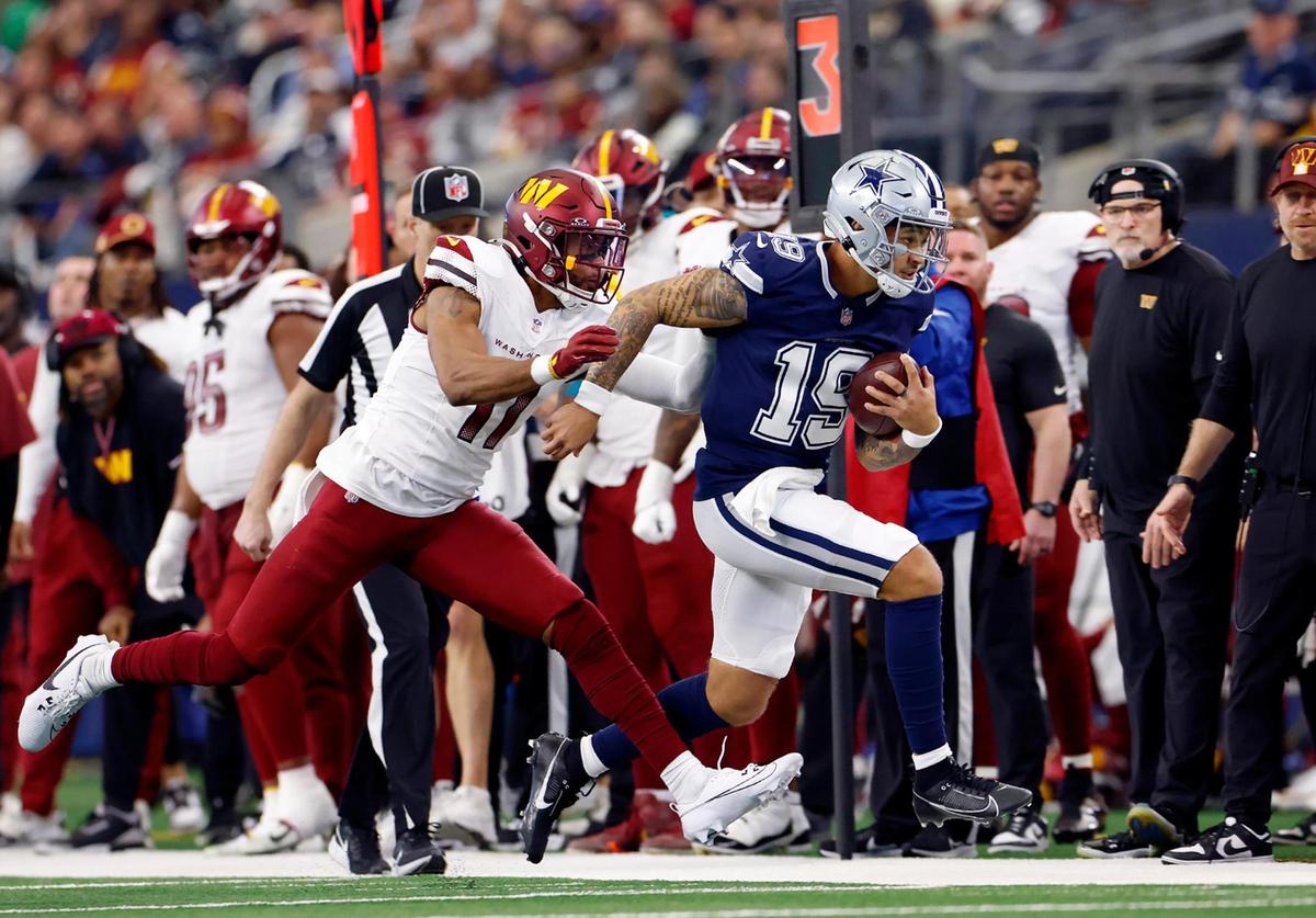 Dallas Cowboys quarterback Trey Lance runs the ball with Washington Commanders strong safety Jeremy Chinn in pursuit at AT&T Stadium in Arlington on Sunday, Jan. 5, 2025.