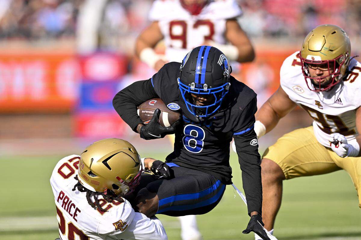 Nov 16, 2024; Dallas, Texas, USA; SMU Mustangs wide receiver Jordan Hudson (8) catches a pass for a first down as he is tackled by Boston College Eagles defensive back KP Price (20) during the first half at the Gerald J. Ford Stadium. Mandatory Credit: Jerome Miron-Imagn Images