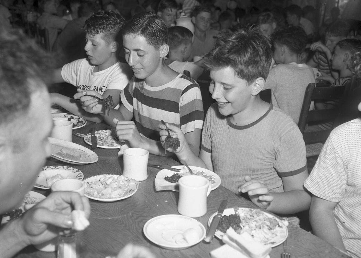 July 26, 1944: Hirschel Kershman, left, son of Mrs. Bessie Kershman; Gilbert Friedson, son of Mr. and Mrs. Ernest Friedson, and Teddy Hendelman, son of Mr. and Mrs. Morris Hendelman, are liking their spinach at Worth Ranch Boy Scout camp.