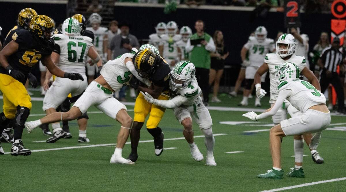 Paradise’s Landon Morrison (55) and Cash Watson (4) bring down Malakoff running back Jason Tennyson (22) in a Class 3A Division 1 state quarterfinal on Thursday, Dec. 12, 2024 at the Ford Center in Frisco, Texas.