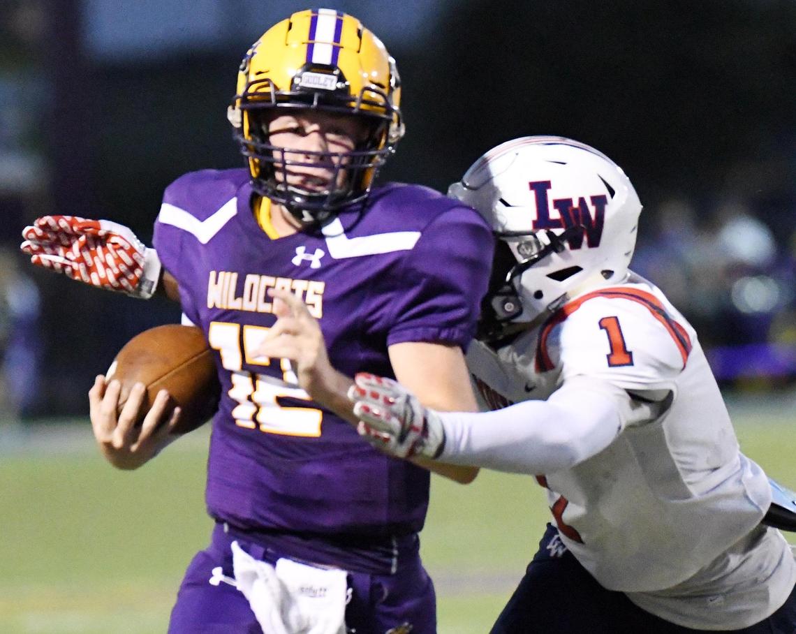 Godley quarterback Caden Burke, left is caught from behind by Life Waxahachie’s Sevin Butleras he races forthe sideline in the second quarter of their Friday, August 28, 2020 football game in Godley, Texas. Special/Bob Haynes