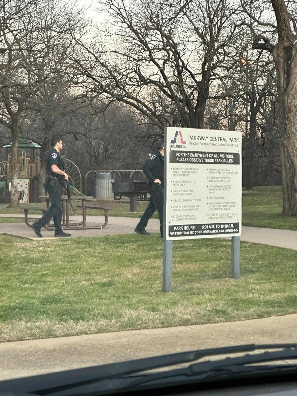 Arlington police officers search near the playground where a child was bitten by a coyote Tuesday evening, Feb. 13, 2024, at Parkway Central Park.