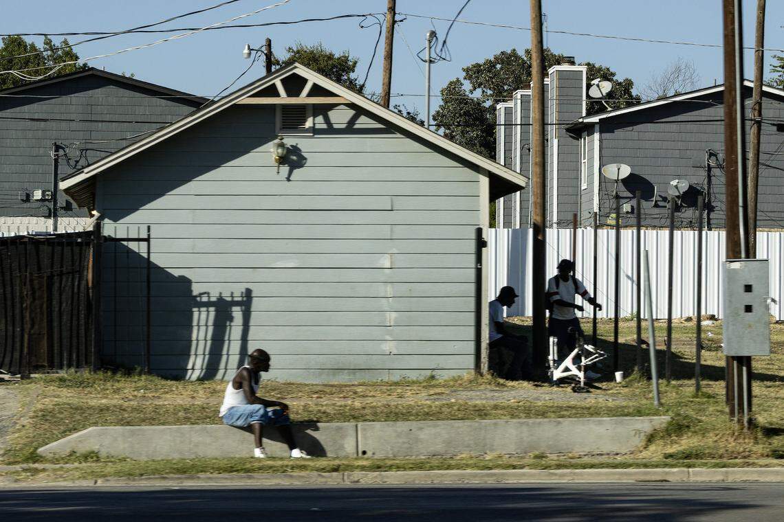 People congregate outside of the Eco Motel on East Lancaster Avenue in Fort Worth on Thursday, Oct. 16, 2025.