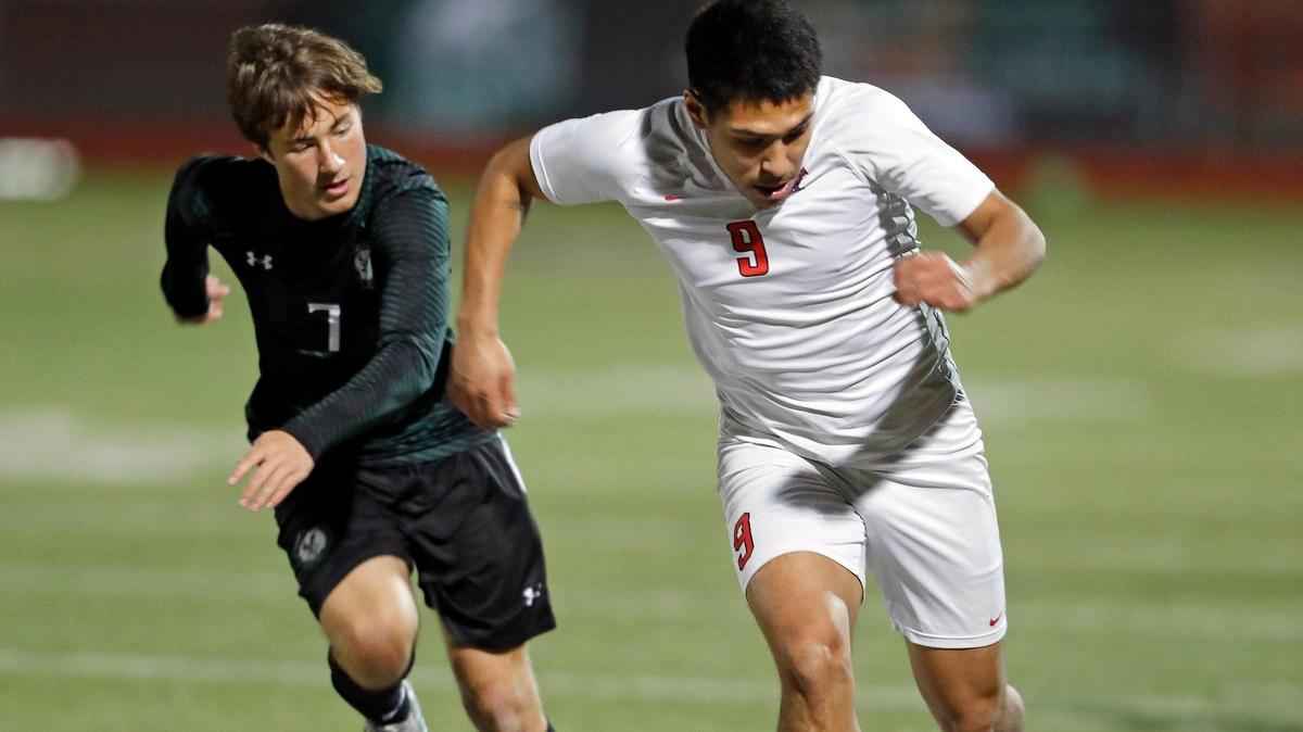 Lake Ridge Mason Cox and Duncanville Alejandro Rojas bring the ball down the sidelines during a 11-6A soccer game at Lake Ridge High School in Mansfield, Texas, Tuesday, Feb. 02, 2021. Lake Ridge and Duncanville fought to a two point tie. (Special to the Star-Telegram Bob Booth)
