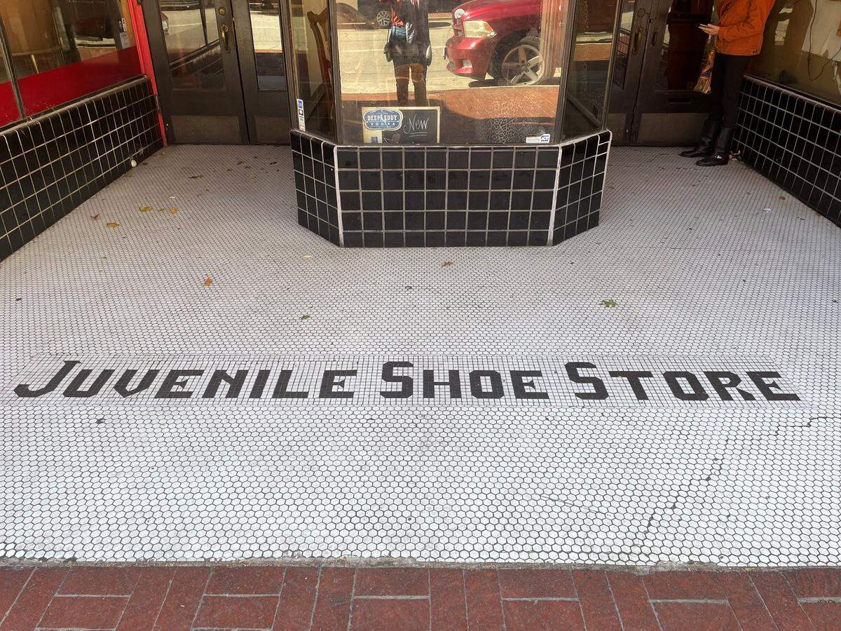 The black-and-white entry tiles refer to the business that operated at 306 N. Houston St. in downtown Fort Worth from 1935 to 1991. For the past two decades the space has been home to the Red Goose Saloon.