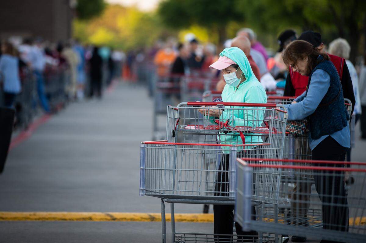 A line of shoppers wraps back and forth in the parking lot at Costco amid the coronavirus outbreak Thursday, March 26, 2020, in Fort Worth.