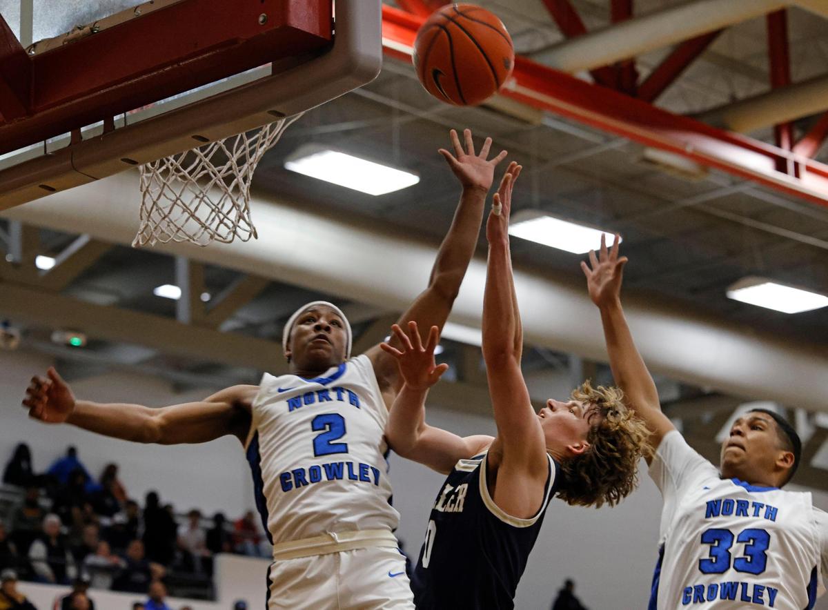 North Crowley guard Kameron Price (2) and post Harvey Tolley (33) defend against Keller guard Maverick McNeil (0) during the first half of the UIL 6A Region I Bi-District playoff game at Martin High School in Arlington, Texas, Monday, Feb. 17, 2025.