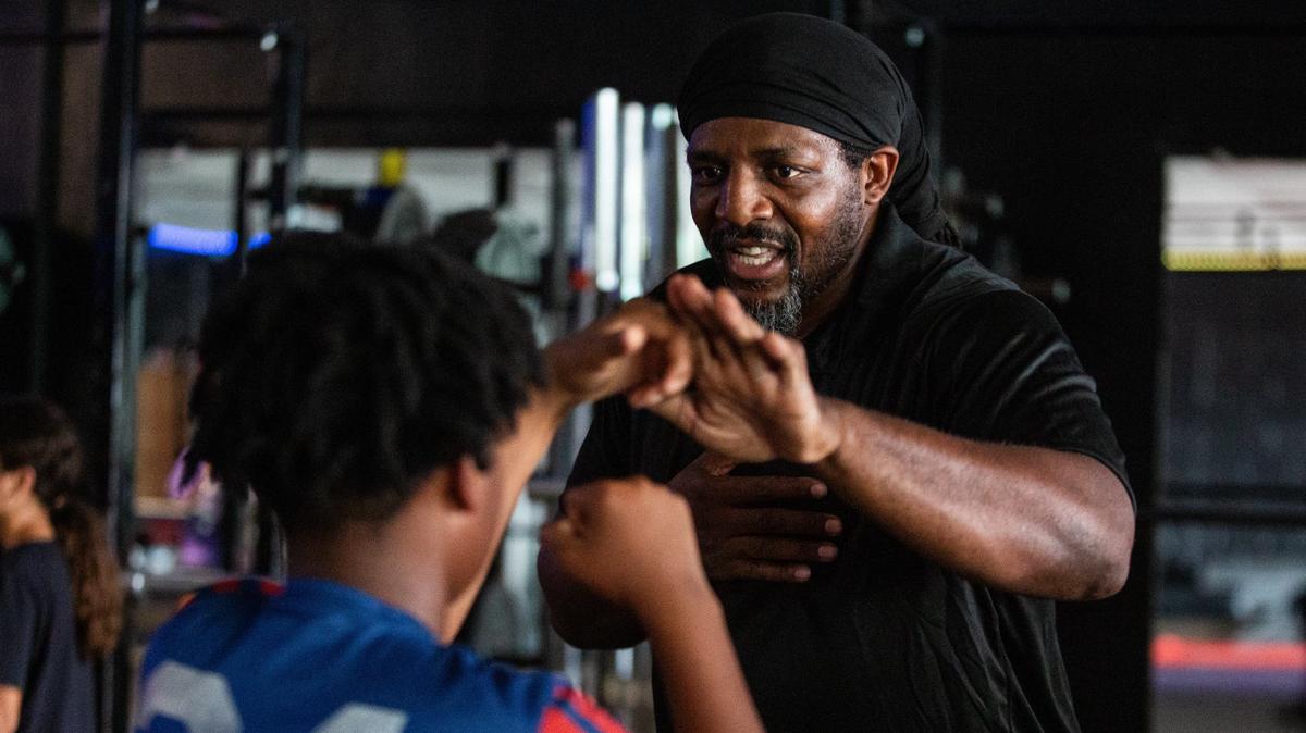 Kendrick Releford Jr. coaches Yogy Ogunyale, 11, on Wednesday, July 30, 2024, at Dream Performance in Fort Worth. Kendrick Releford Jr. is the son of a famous golden glove boxer in Fort Worth and is working to revitalize the local boxing scene by teaching with an ultimate goal of bringing the sport back to high schools.