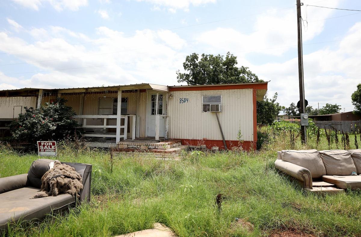 A mobile home is advertised for sale in the neighborhood next to a bitcoin mining facility in Granbury on Wednesday, May 29, 2024.