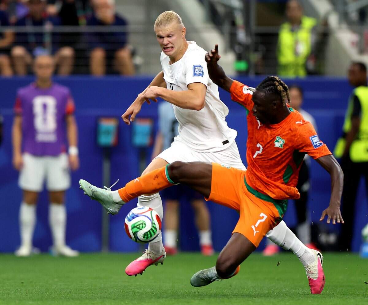 Norway striker Erling Haaland and Ivory Coast defender Odilon Kossounou fight for possession of the ball during the 2026 FIFA World Cup knockout match on Tuesday, June 30, 2026, at Dallas Stadium in Arlington.
