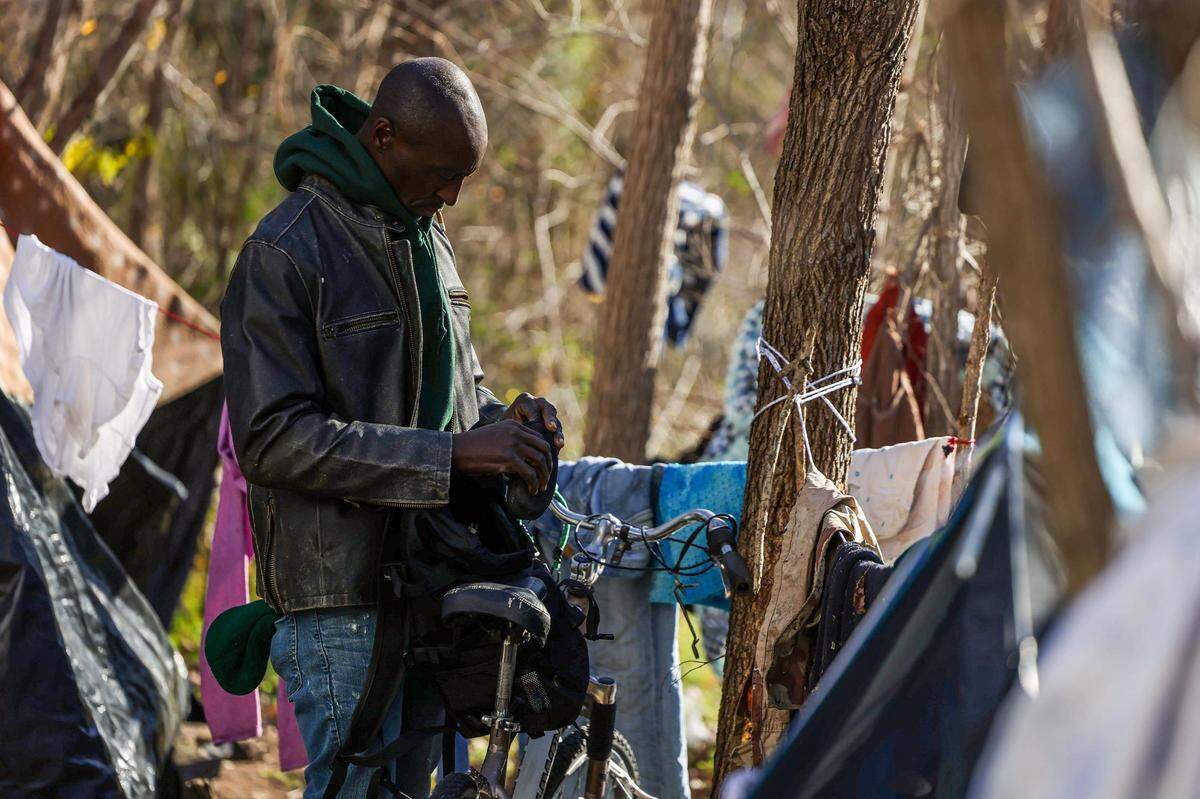 Ronald Northern organizes his living quarters tucked behind an old drive in movie theater in Fort Worth on Jan. 9. Northern, who has been experiencing homelessness for several years after getting out of prison, said medical care is more accessible for him through the street medicine team rather than taking the bus to the emergency room.