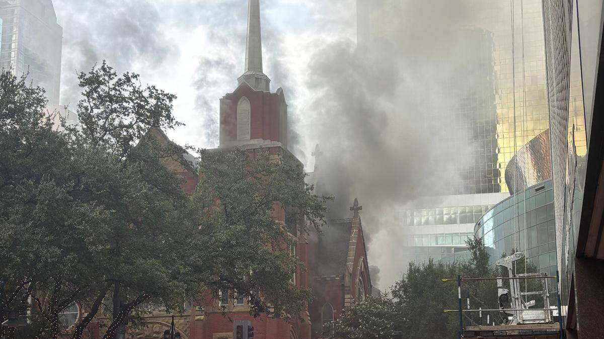 Firefighters battle a church fire at First Baptist Dallas at North Ervay Street and San Jacinto Street in downtown Dallas on Friday, July 19, 2024.