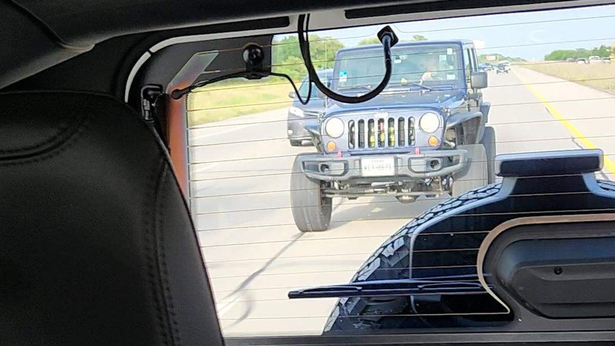 A screen grab shows a Jeep beginning to pass the Goodwin family’s car on the right before it hits their back tire while driving on Interstate 30 near Eastchase Parkway.
