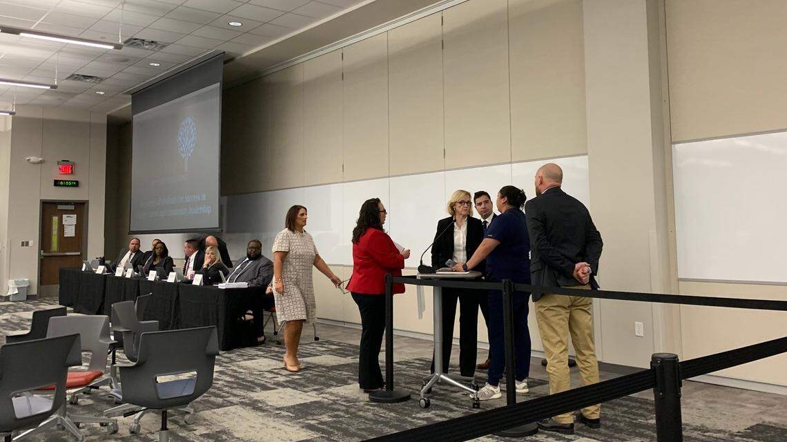 Fort Worth school superintendent Angelica Ramsey and board president Tobi Jackson talk with a parent who had a child dropped off at the wrong bus stop after her mic was cut off for trying to play an audio recording. The recording, which sounded like children crying, was not identified before the mother and other parents were taken into another room to speak with the superintendent.