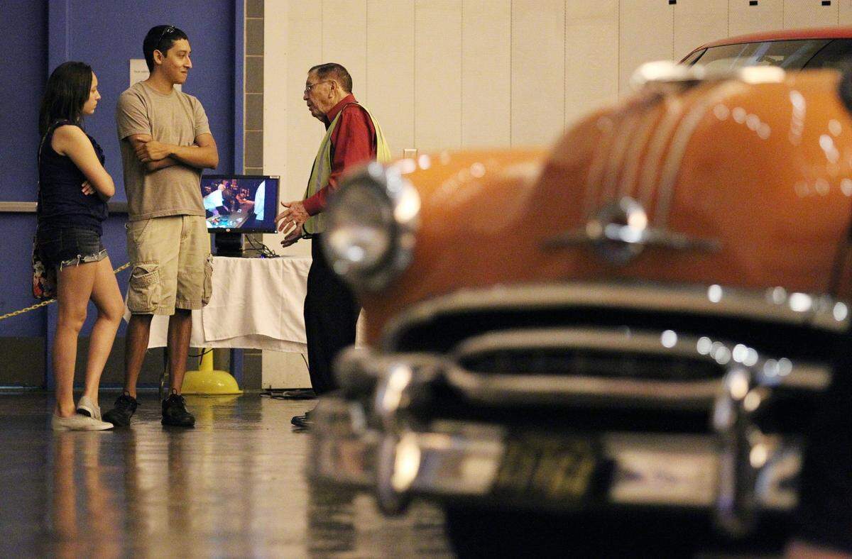 June 12, 2012: Sabrina and Gilbert Trejo visit with retired longtime GM worker Morgan Hogue (1955-1980) at the Arlington Assembly plant. The plant’s museum shows several vintage autos, including a 1954 Pontiac Starchief, the 1,731st vehicle made in Arlington. Plant workers restored it.