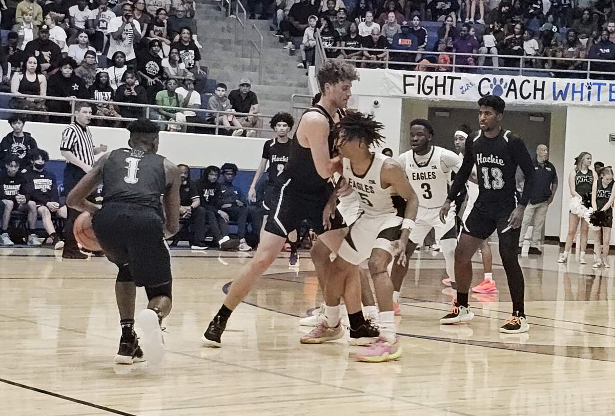 Waxahachie guard King Grace (1) gets a screen from Parker Jefferson (center) on Mansfield Lake Ridge forward Ahmare Rose (5) in a Class 6A Region II quarterfinal on Monday, February 26, 2024 at Midlothian High School in Midlothian, Texas. Lake Ridge defeated Waxahachie 78-63.
