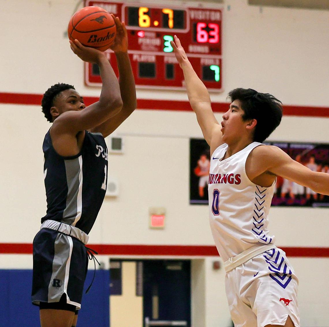 Richland guard Jalen Nettles (L) attempts a three point shot against Grapevine guard Riley Park (0) during the second half of a High School basketball game, January 25, 2021, played at Grapevine High School in Grapevine, Tx. (Steve Nurenberg Special to the Star-Telegram)