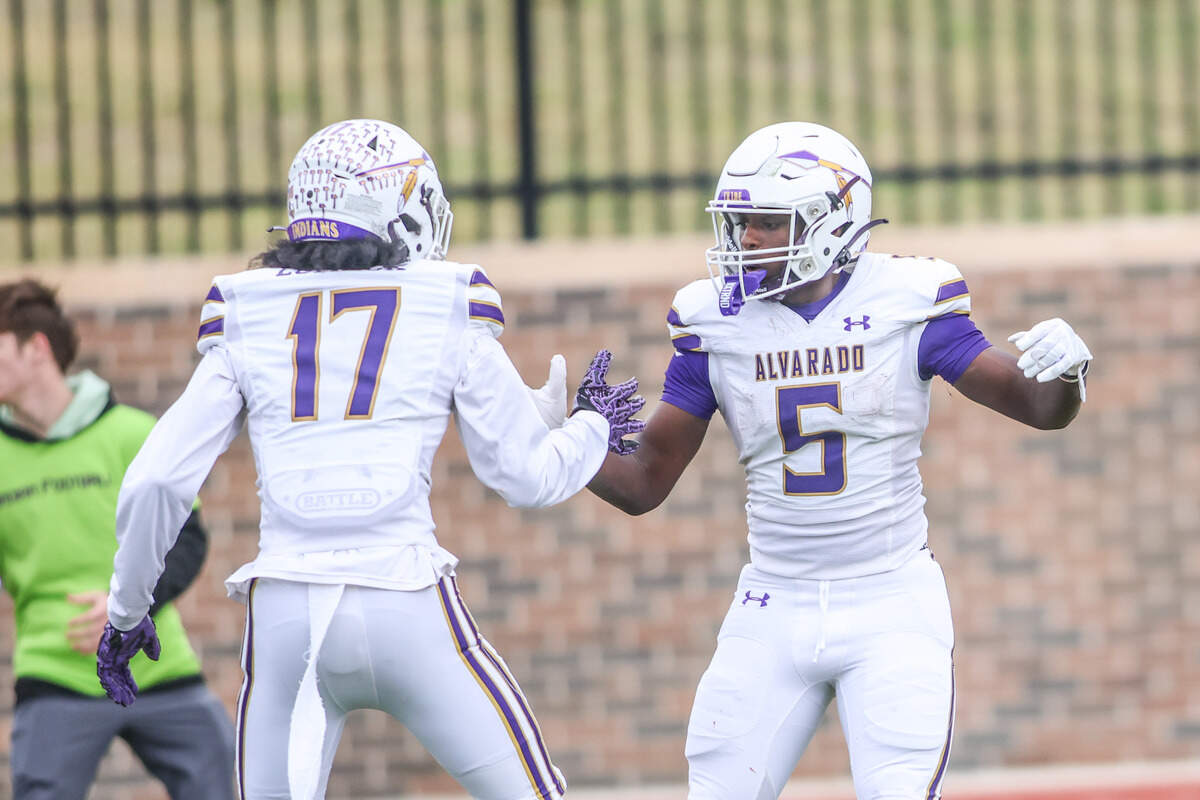 Alvarado running back Demarcus Belton (5) celebrates his long touchdown reception with Kenneth Lomack during a Class 4A Division I regional semifinal Friday at Eagle Mountain High School.