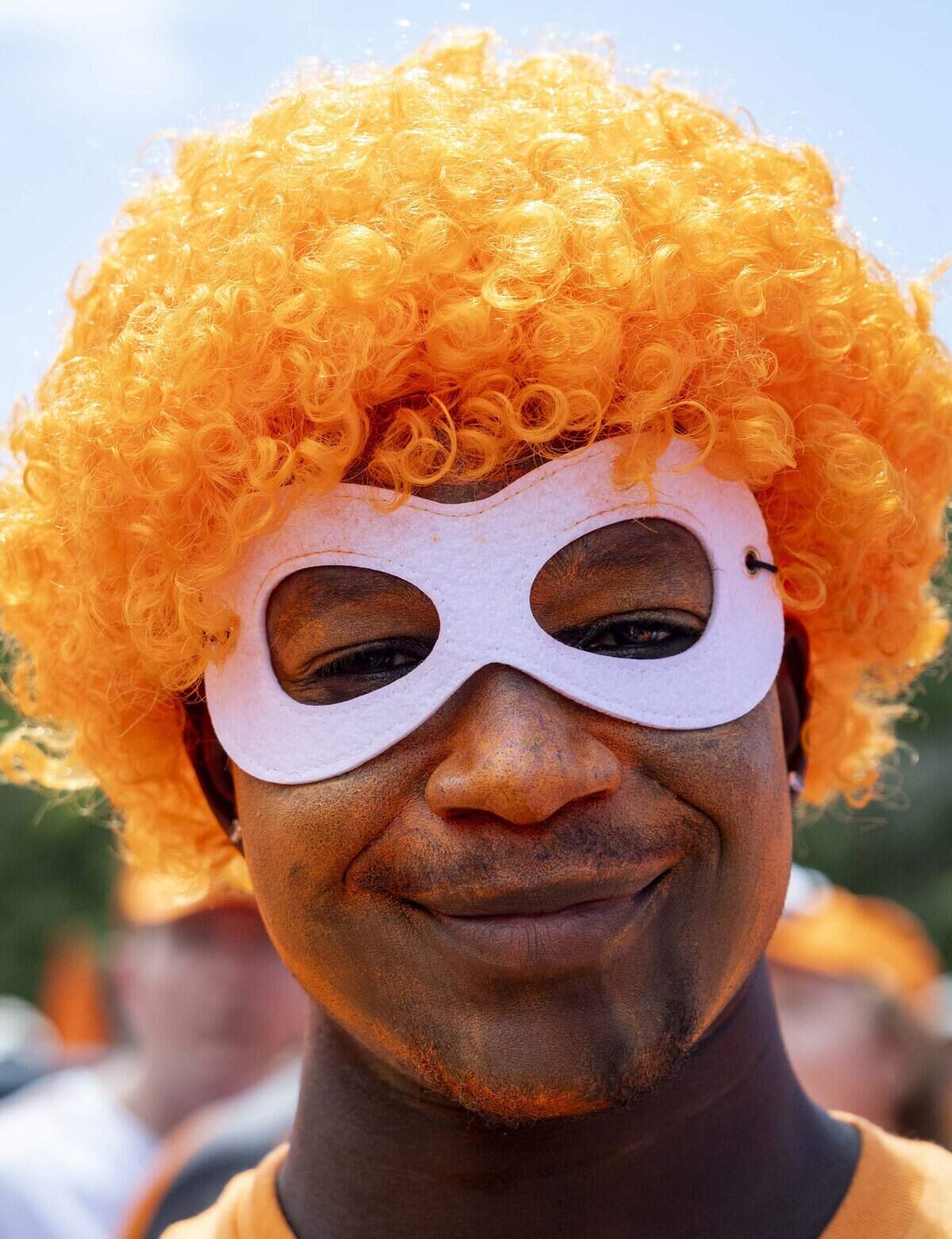 Anthony Chike of Dallas sports face paint and an orange wig for the FIFA World Cup between the Netherlands and Japan on Sunday, June 14, 2026 in Arlington, Texas.