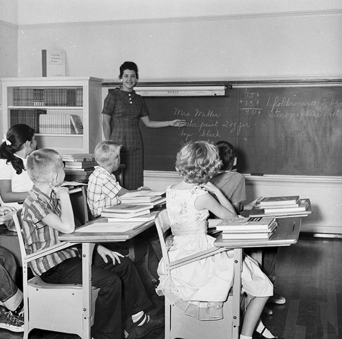 Sept. 2, 1958: Fourth-grade students at South Hi Mount watch Mrs. Betty Miller as she points to her name on the blackboard. The pupils had to print teacher’s name on various first-day forms. It helped them learn her name and clear paperwork before serious business of study.