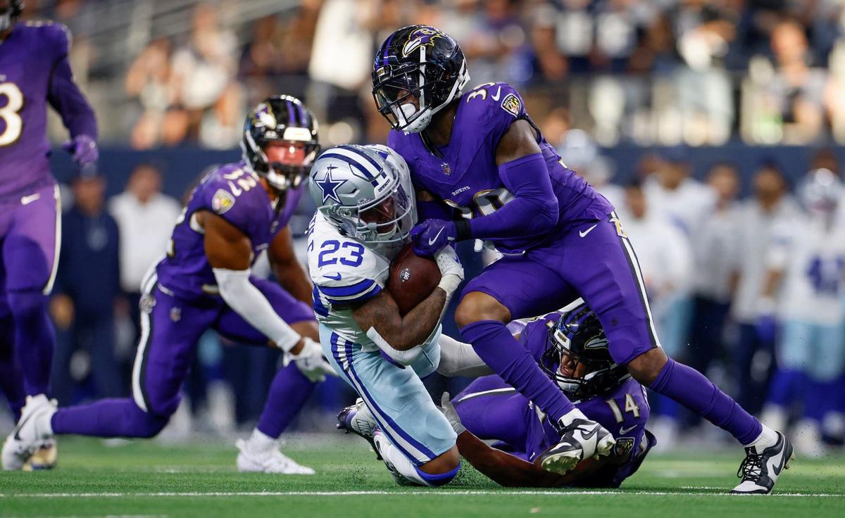 Dallas Cowboys running back Rico Dowdle is tackled by Baltimore Ravens safety Eddie Jackson during the fourth quarter on Sunday, Sept. 22, 2024 at AT&T Stadium in Arlington.