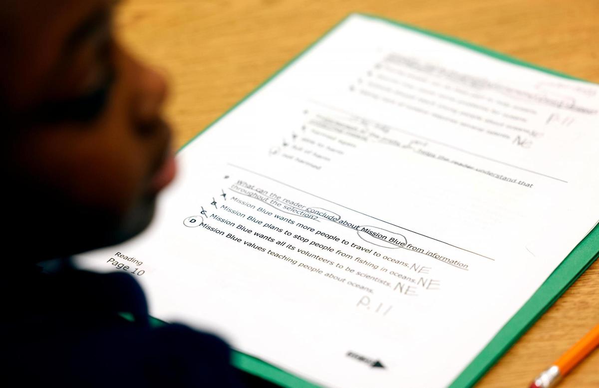 Students work on reading comprehension with retired teacher Wanda Mckenzie at Clifford Davis Elementary School on Feb. 3.