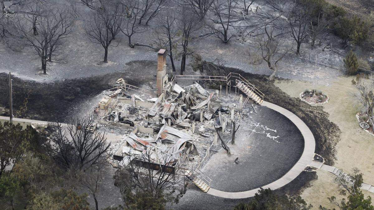 A large home is left in ashes in Gaines Bend on Possum Kingdom Lake during the PK Complex Fire of 2011.