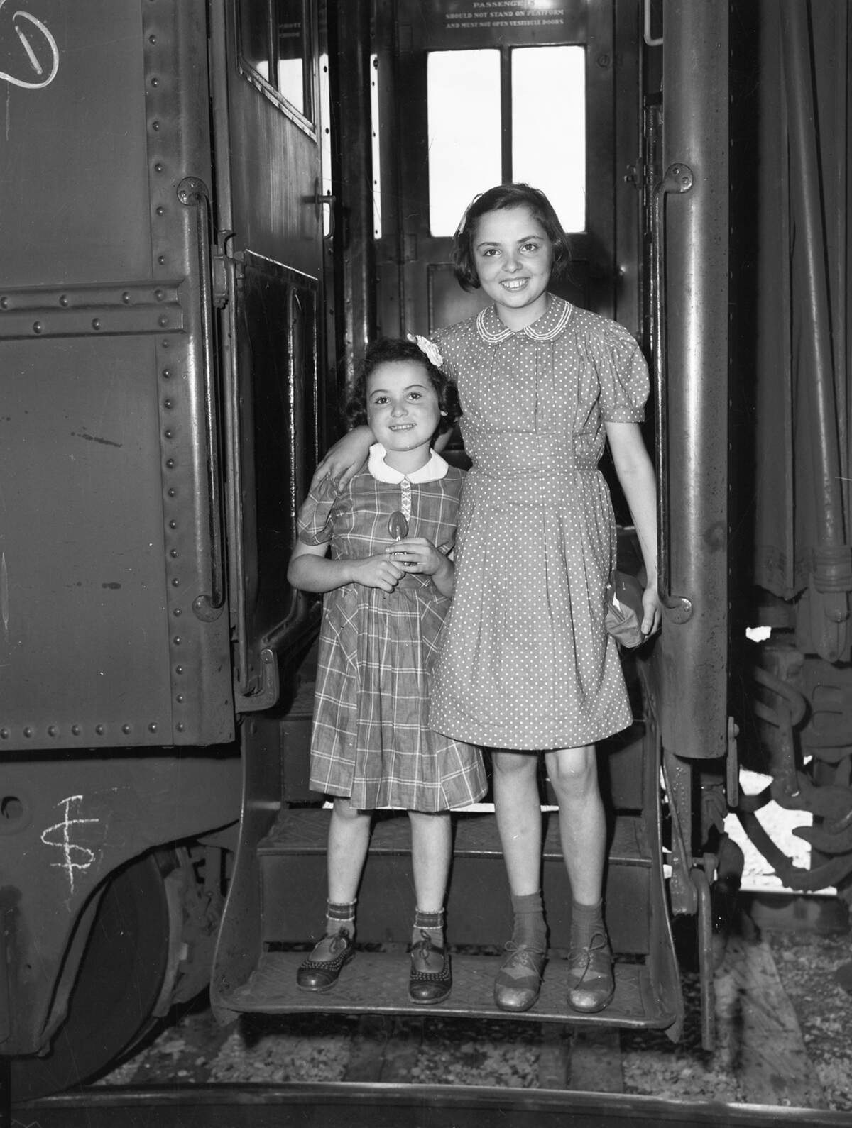 The Kokotek sisters - Inge, 9, left, and Elsa, 13 - step off a train Sept. 8, 1941, after a three-year odyssey that took them on an orphans’ train to Paris, into hiding at a French chateau, by train to the port of Lisbon, across the Atlantic on a Mercy Ship, and finally from New York to Texas.