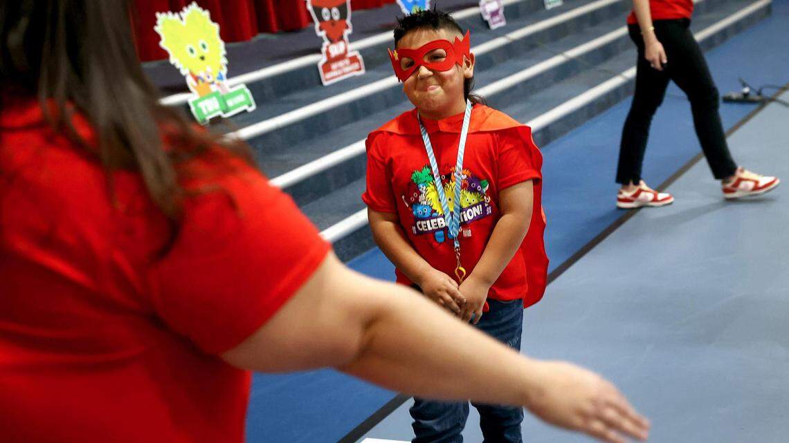 Ramon Rodriguez Jr., a second-grader at Cesar Chavez Elementary, turns to give his mother, Nadia, a hug after being named an American Heart Association Youth Heart Ambassador during a school assembly on Friday. As a Youth Heart Ambassador, Rodriguez, who was born with his heart upside down, will share his story of living with heart disease.