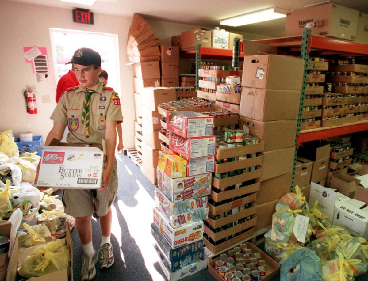 Aug. 9, 1999: Boy Scout Corey Pemberton, 13, of Southlake carries some of the 1,880 items they collected into the GRACE Food Pantry in Grapevine. Troop 928 scouts, Pemberton and Phillip Flick, organized the donations for a service project.