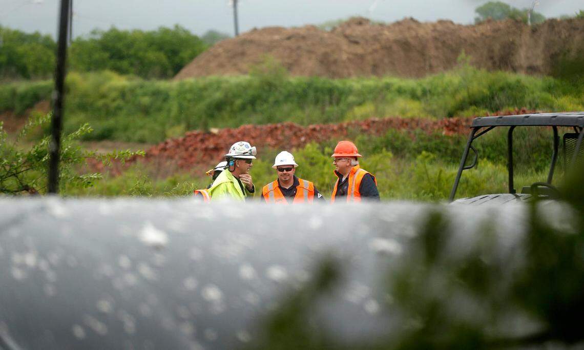 A crew looks over the location of a train derailment in Fort Worth. Several train cars derailed early Wednesday and caught fire.