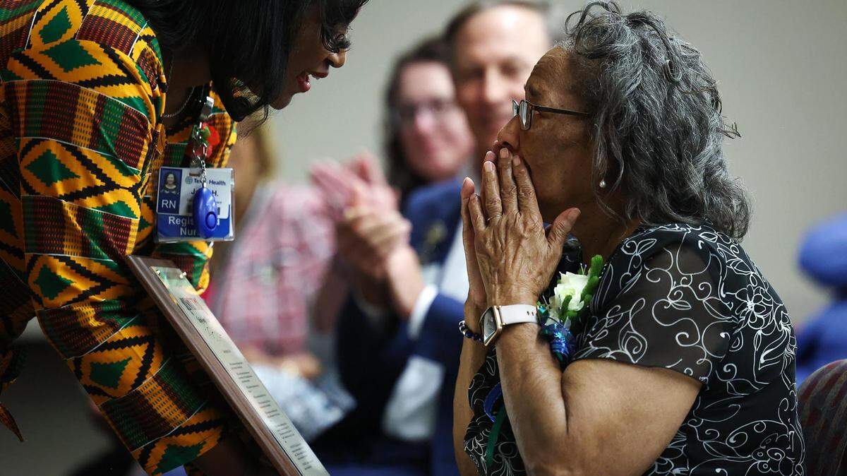 Margaret Taylor, right, is presented with a resolution Monday from the Tarrant County Court of Commissioners honoring her as the first Black nurse in Arlington at Texas Health Arlington Memorial Hospital in Arlington. Taylor worked at the Arlington Memorial Hospital, now Texas Health Arlington Memorial Hospital, from 1967 to 2014.