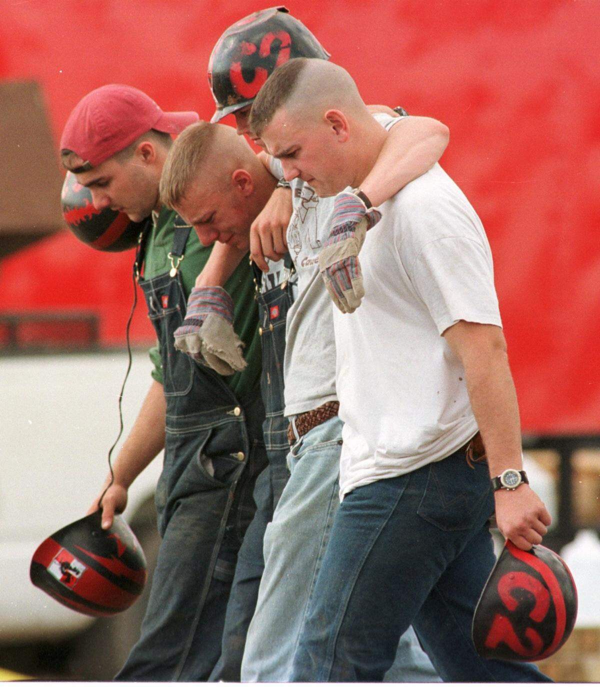 After removing logs from the fallen Texas A&M bonfire in College Station, student volunteers walk away from the scene. Twelve people died in the accident on Nov. 18, 1999.