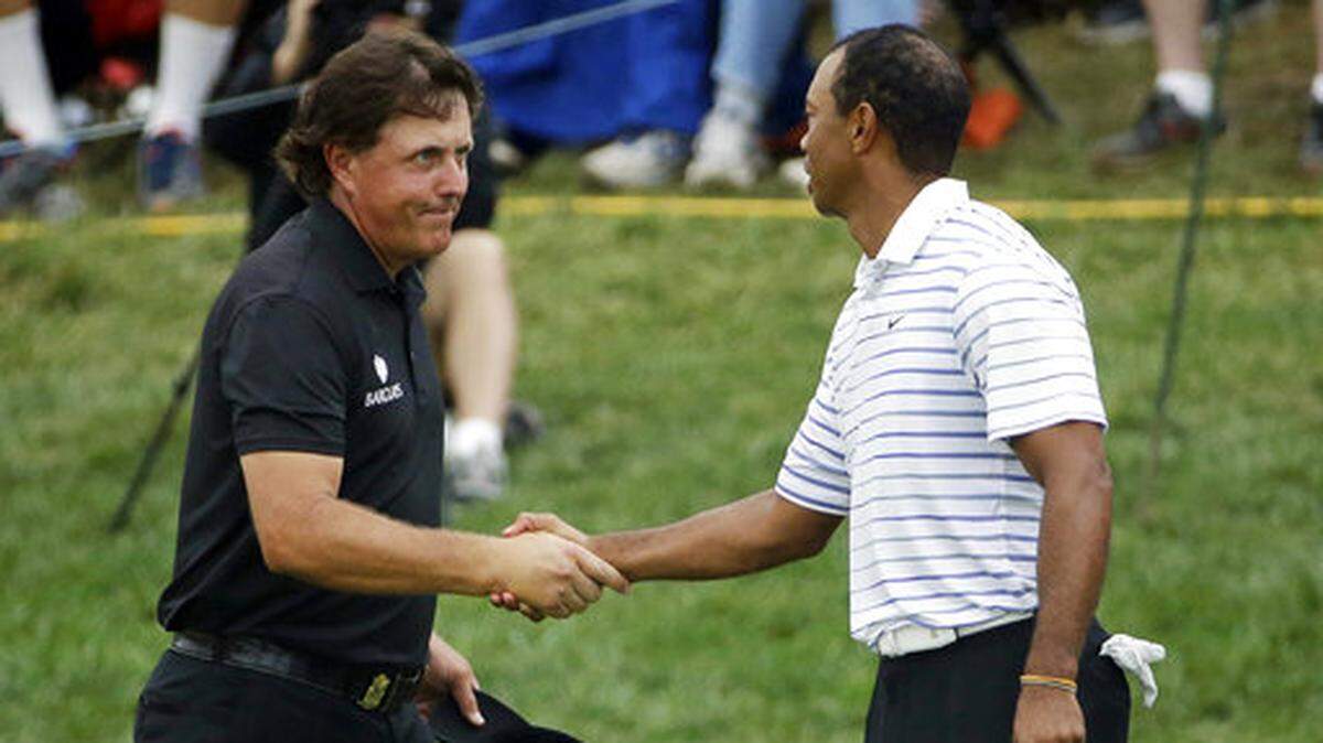 Phil Mickelson, left, shakes hands with Tiger Wood after the second round of the PGA Championship golf tournament at Valhalla Golf Club in Louisville, Ky. The two will reportedly play for $10 million in a 1-on-1 setting during Thanksgiving weekend. (AP Photo/David J. Phillip, File)