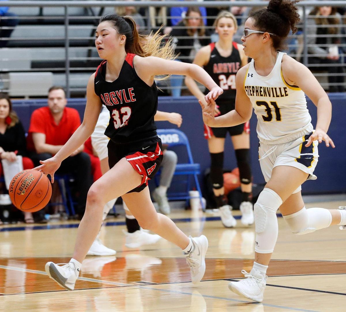 Atgyle’s Madi Lumsden is chased down court by Stepenville’s Mya Wesley during a high school 4A Region 1 Area Round playoff basketball game at Weatherford High School in Weatherford, Texas, Thursday, Feb. 11, 2022. Argyle defeated Stephenville 56-41. (Special to the Star-Telegram Bob Booth)